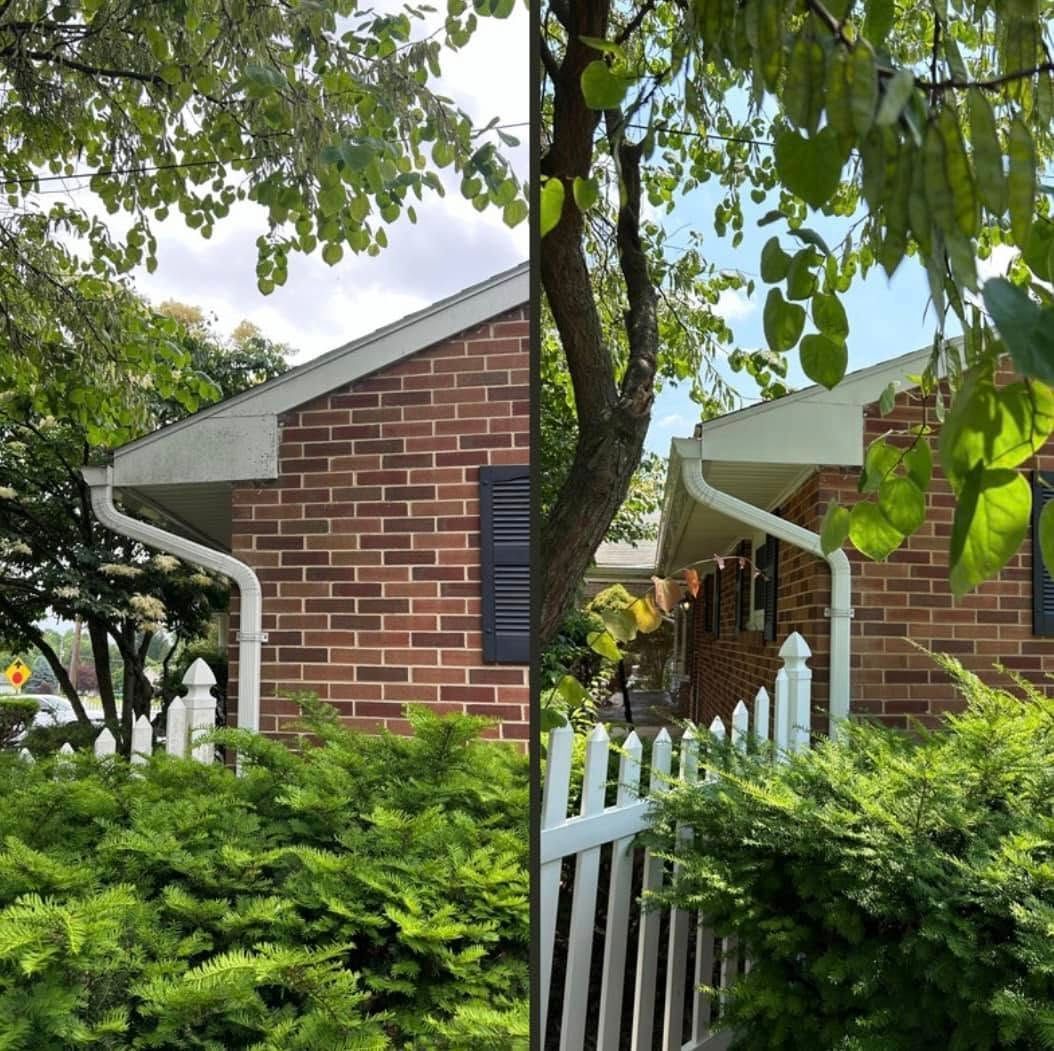 A brick house with a white picket fence in front of it