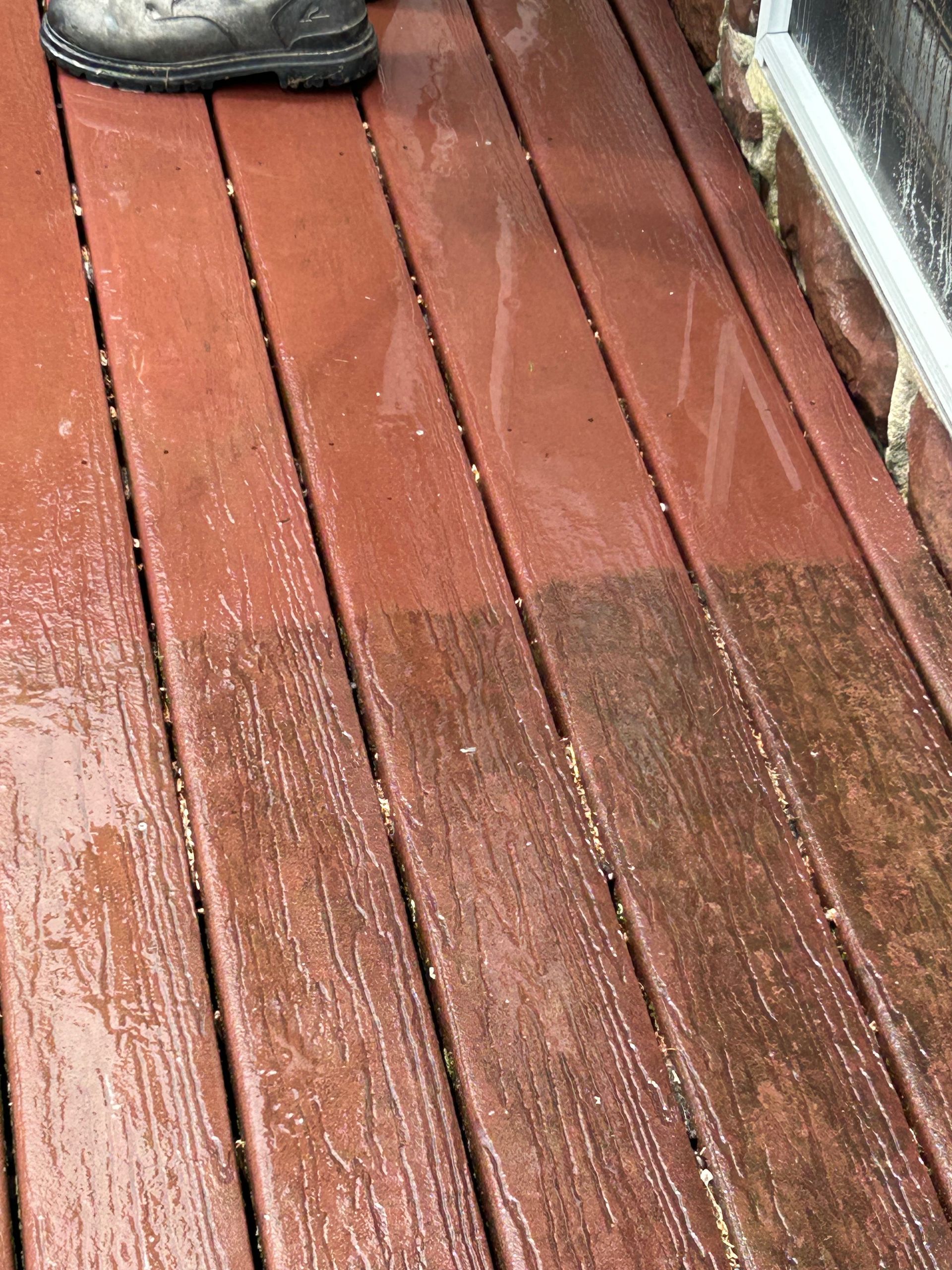 A person is standing on a wooden deck.