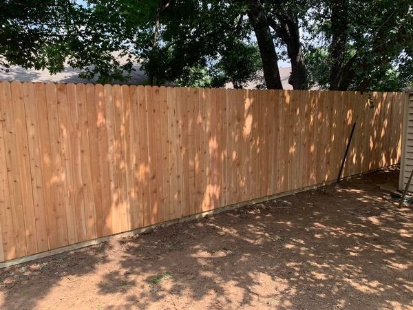 New wooden fence in a yard.