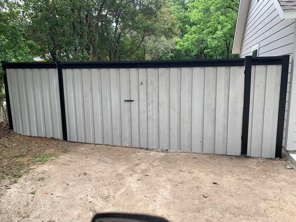 Metal panel fence with black trim.