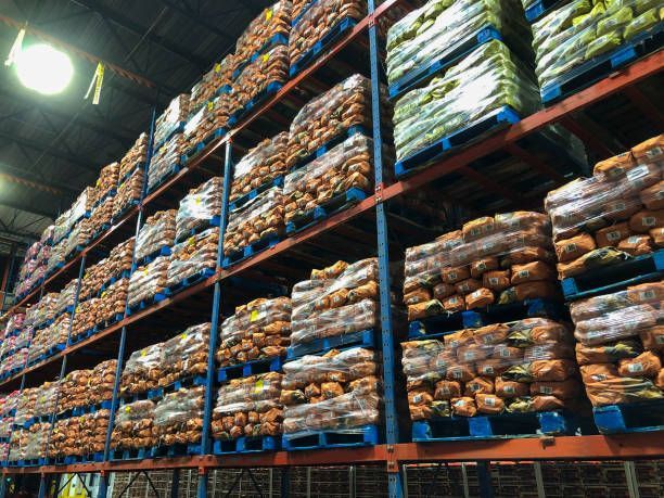 A warehouse filled with lots of pallets of food