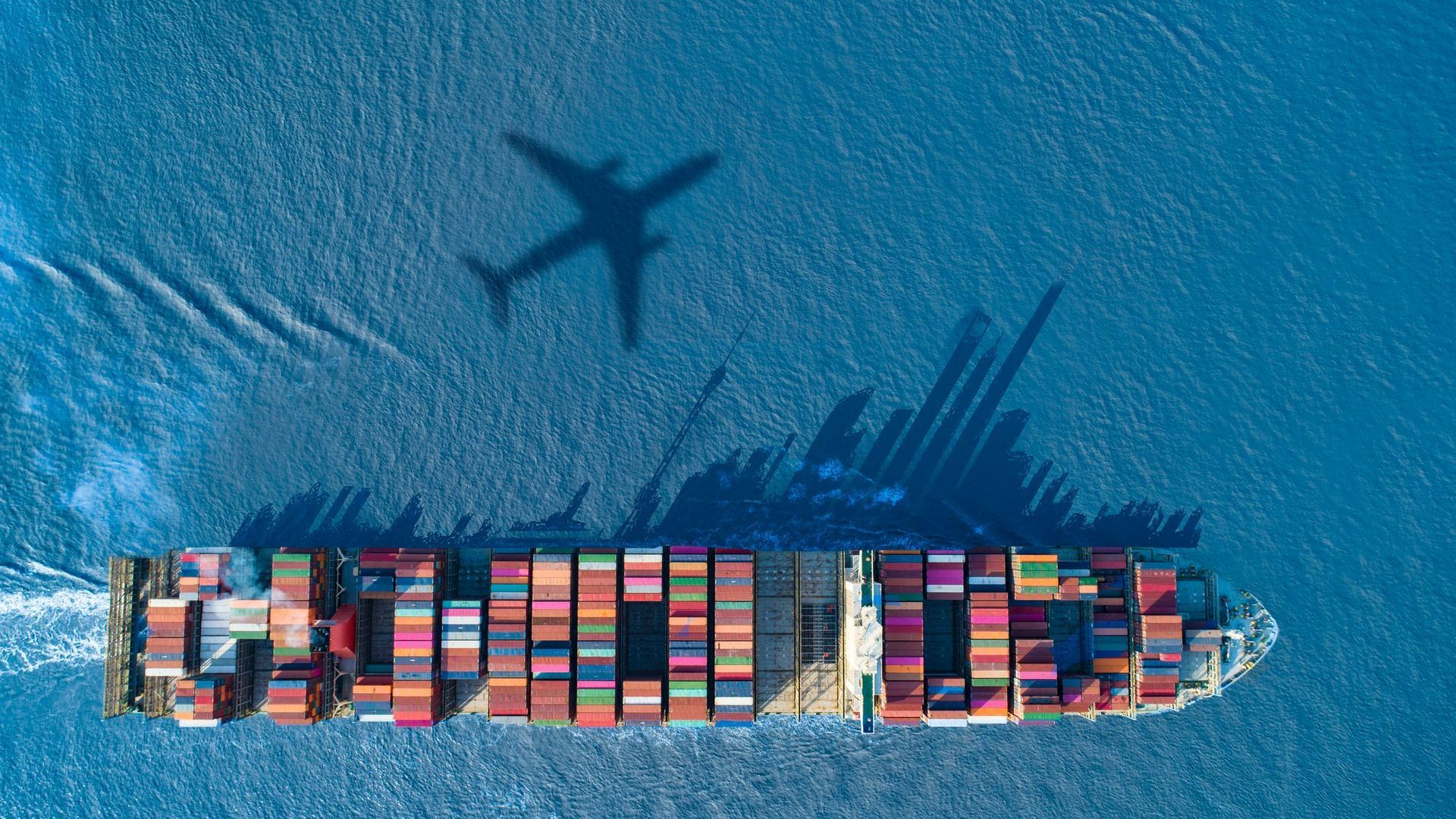 An aerial view of a large container ship in the ocean.
