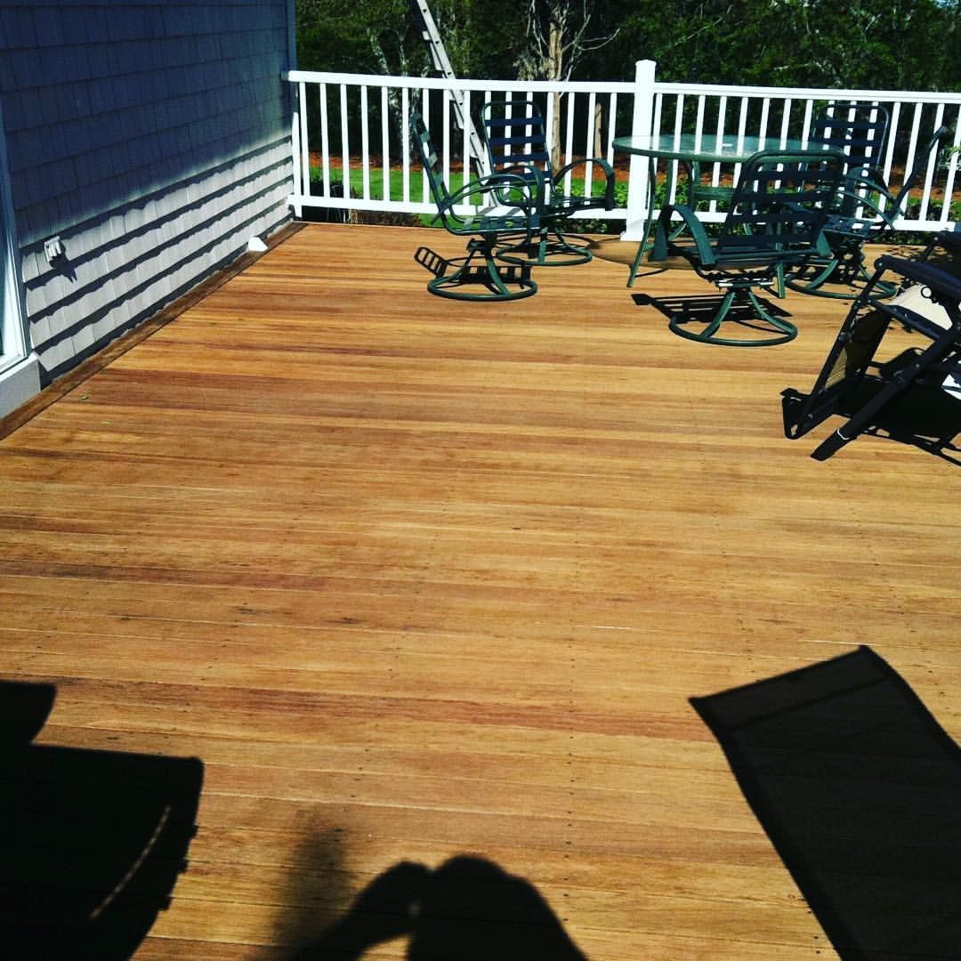 A wooden deck with tables and chairs on it