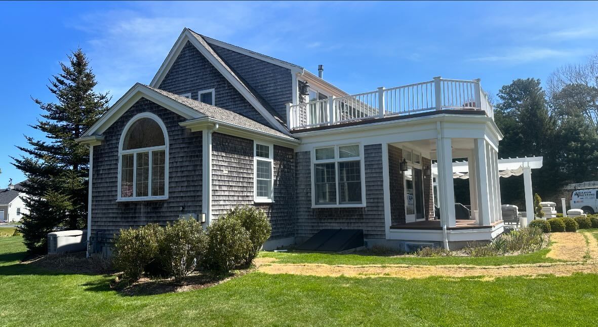 A small house with a large porch on top of it