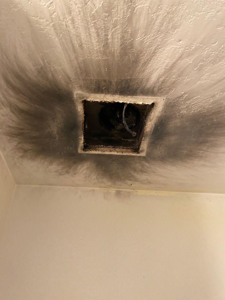 There is a hole in the ceiling with smoke coming out of it.