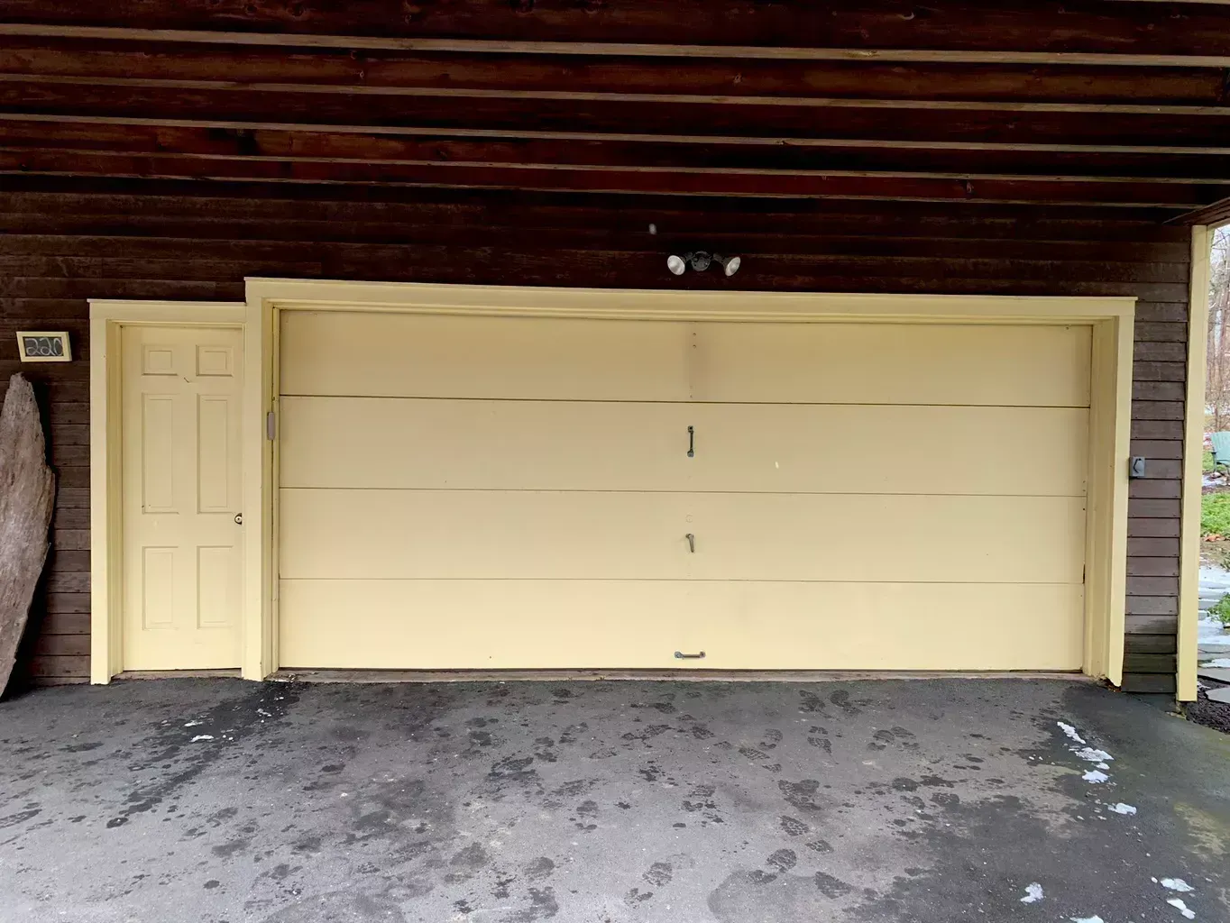 A yellow garage door with the number 1 on it
