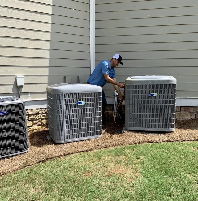 Air Conditioning Maintenance — Man Checking New Air Condition in Bogart, GA