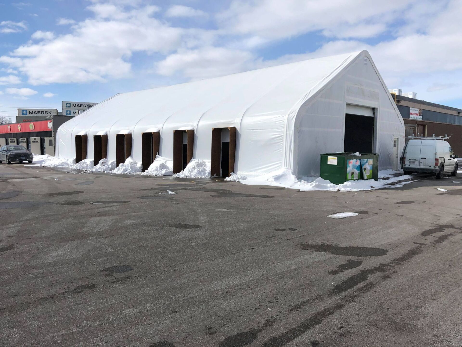 Multiple side garage doors.