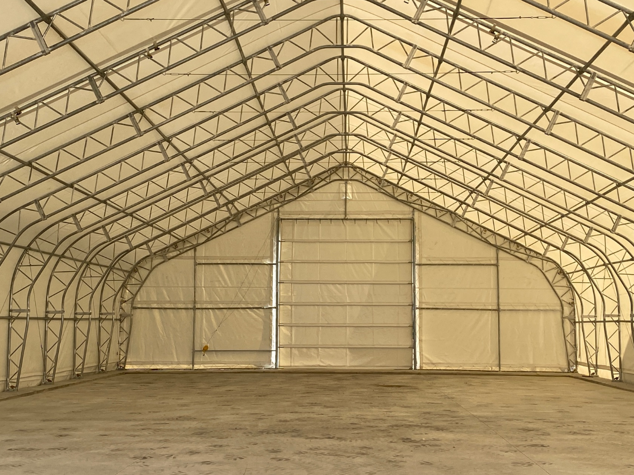 A large empty warehouse with a large sliding door.