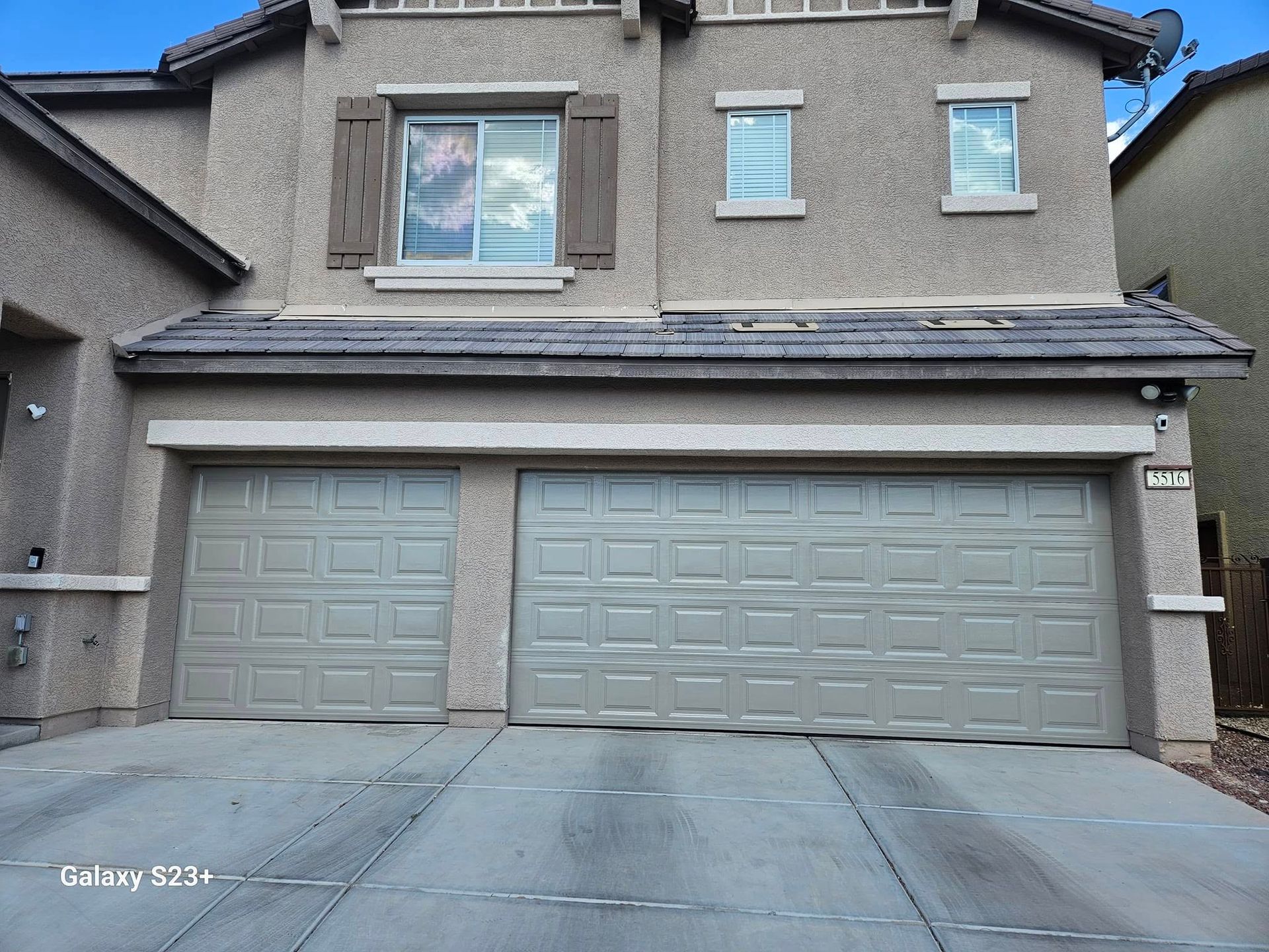 The front of a house with two garage doors