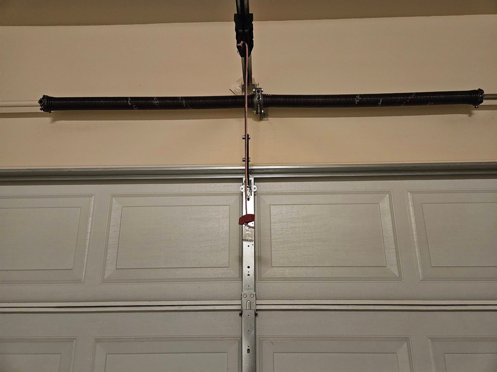 A garage door with a spring attached to it