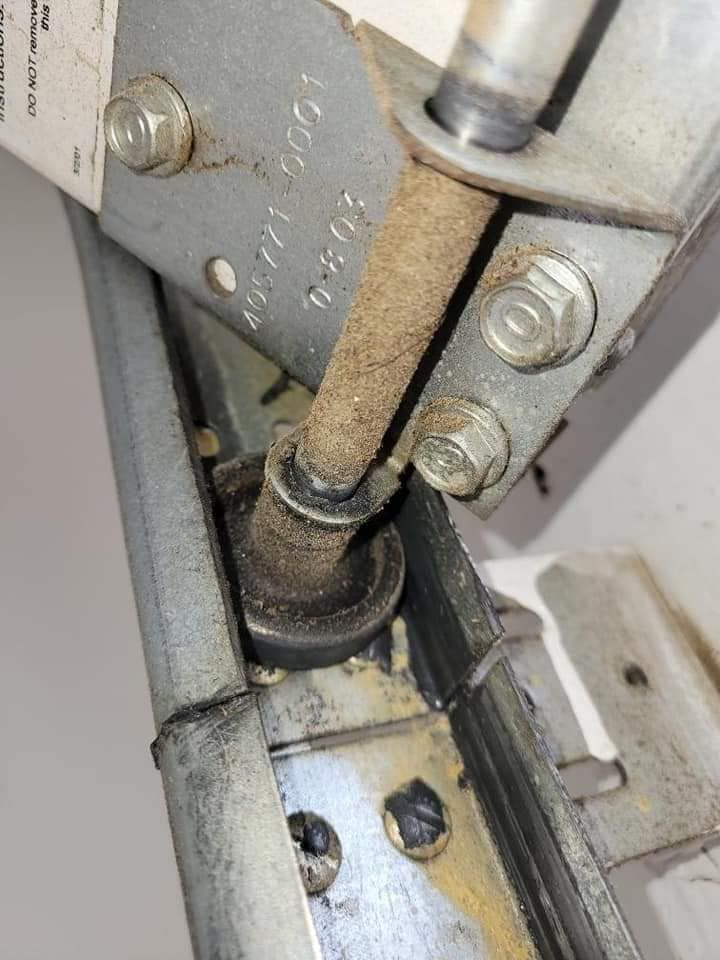 A close up of a metal object with a screw in it.