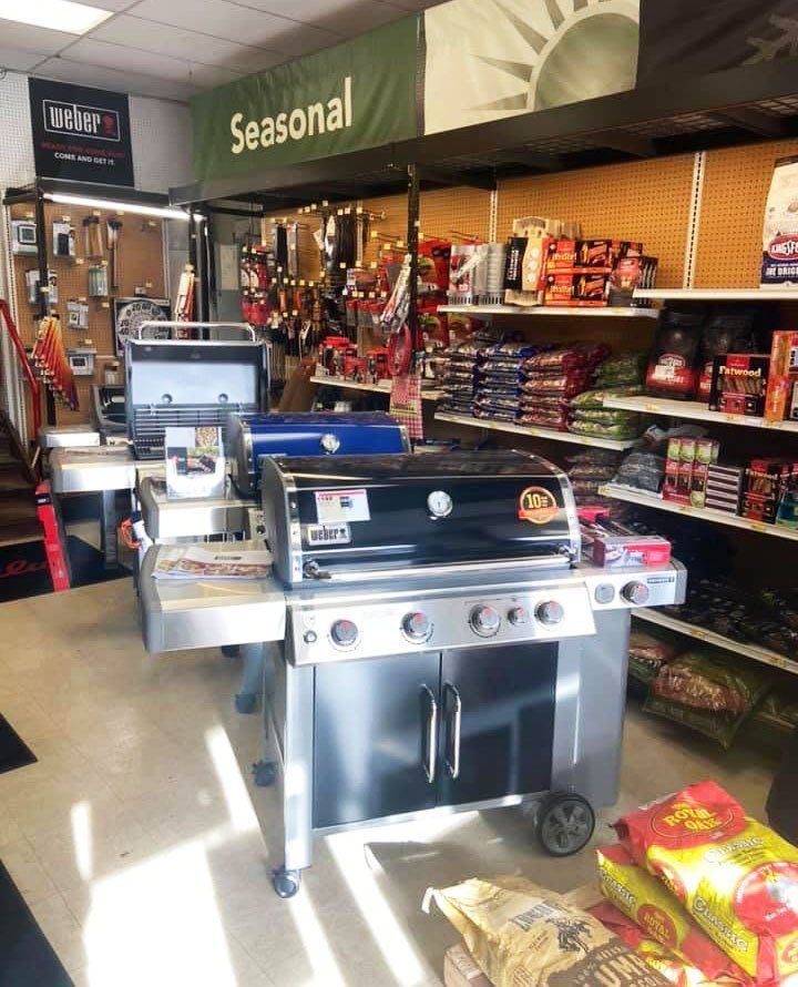 Grills displayed inside a store under a 