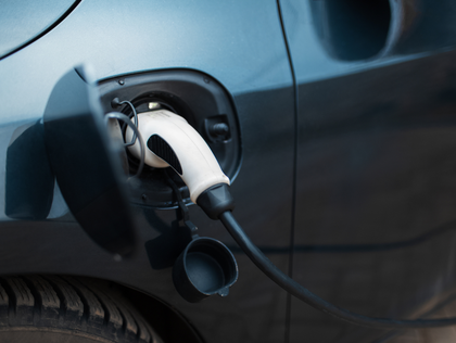 Electric vehicle charging, a plug connected to the car's port.