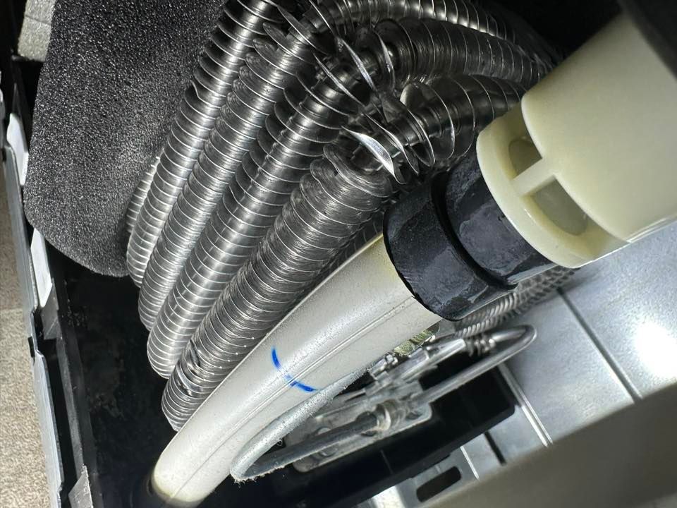 A close up of a vacuum cleaner with a hose attached to it