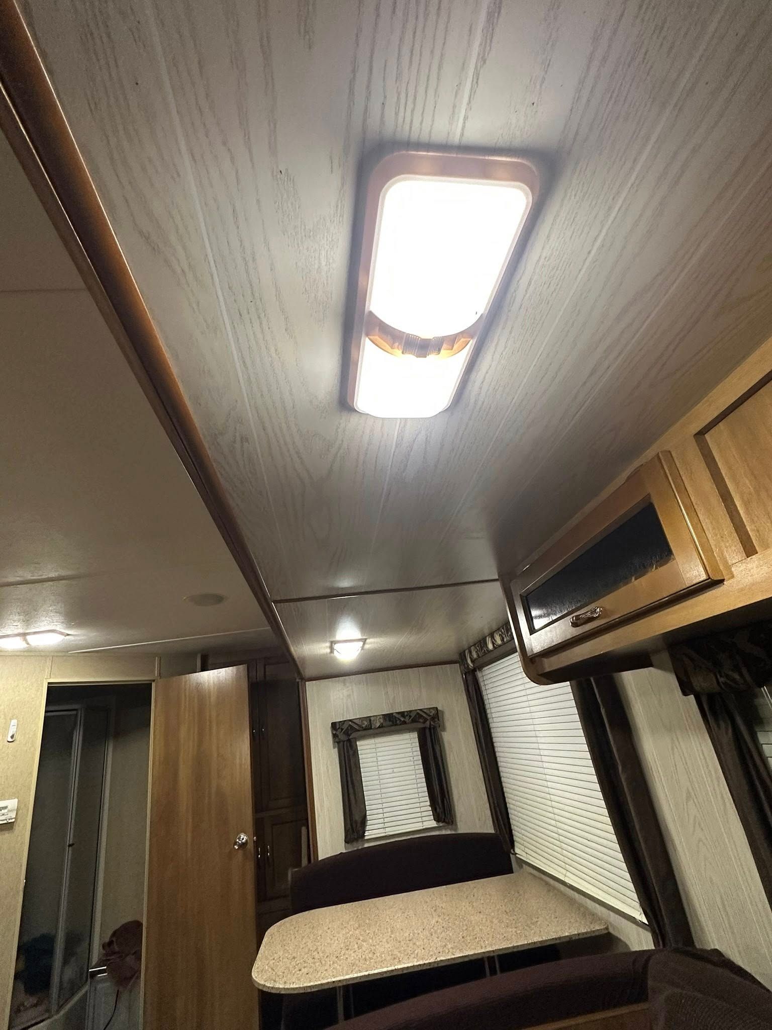 A ceiling light is hanging from the ceiling of a rv.