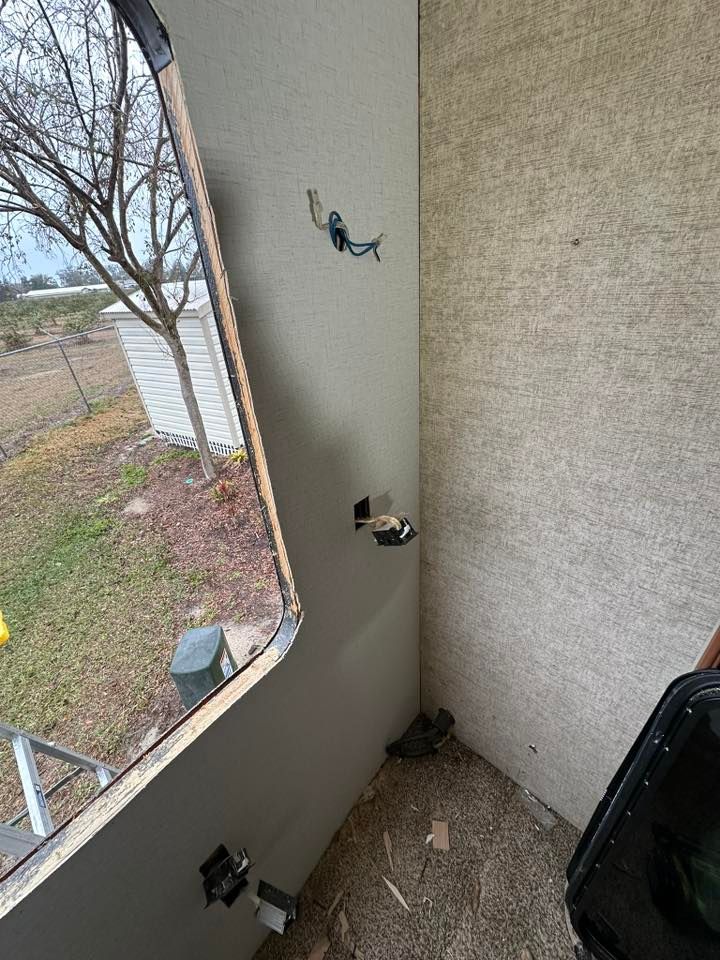 A room with a window and a carpeted floor.