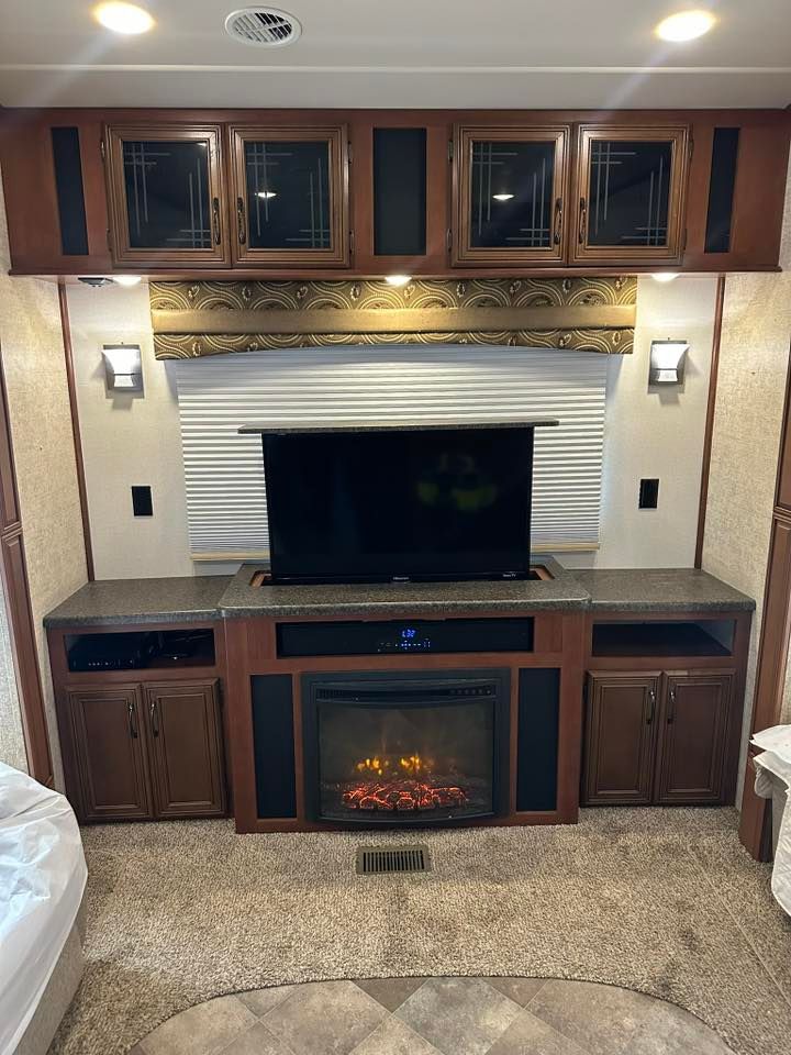 A living room with a fireplace and a flat screen tv.