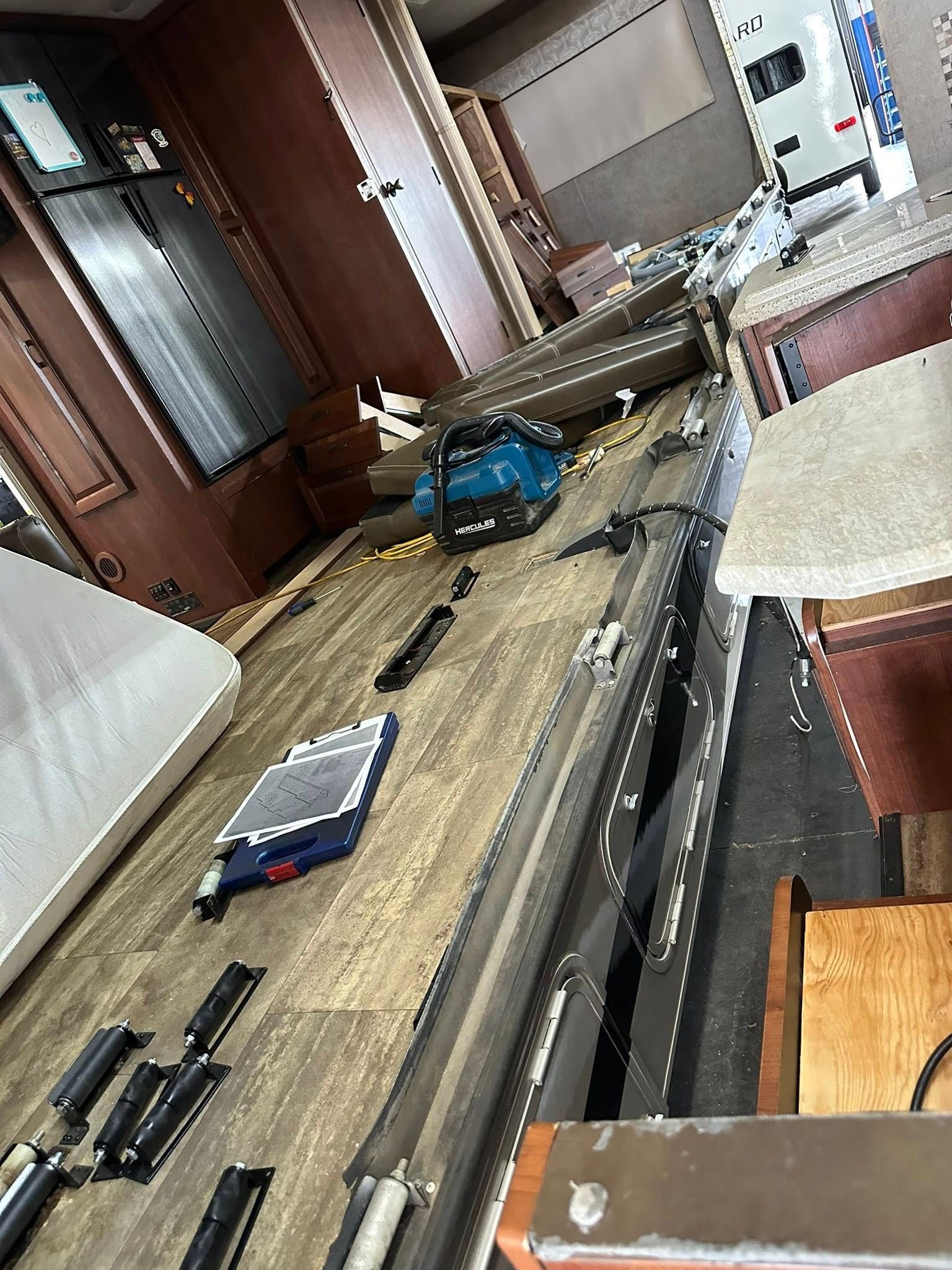 A wooden table with a lot of tools on it in a room.