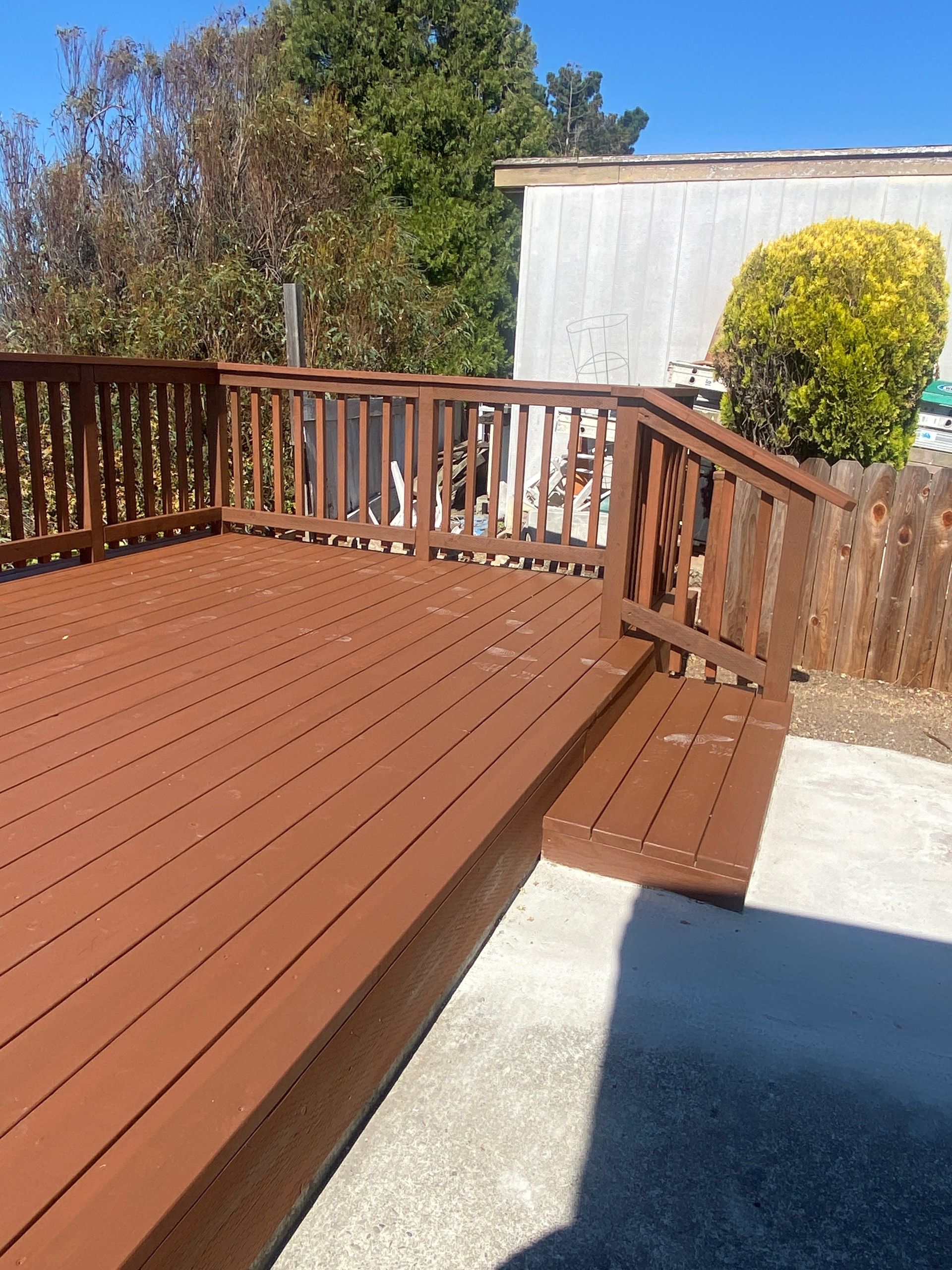 A wooden deck with stairs leading up to it