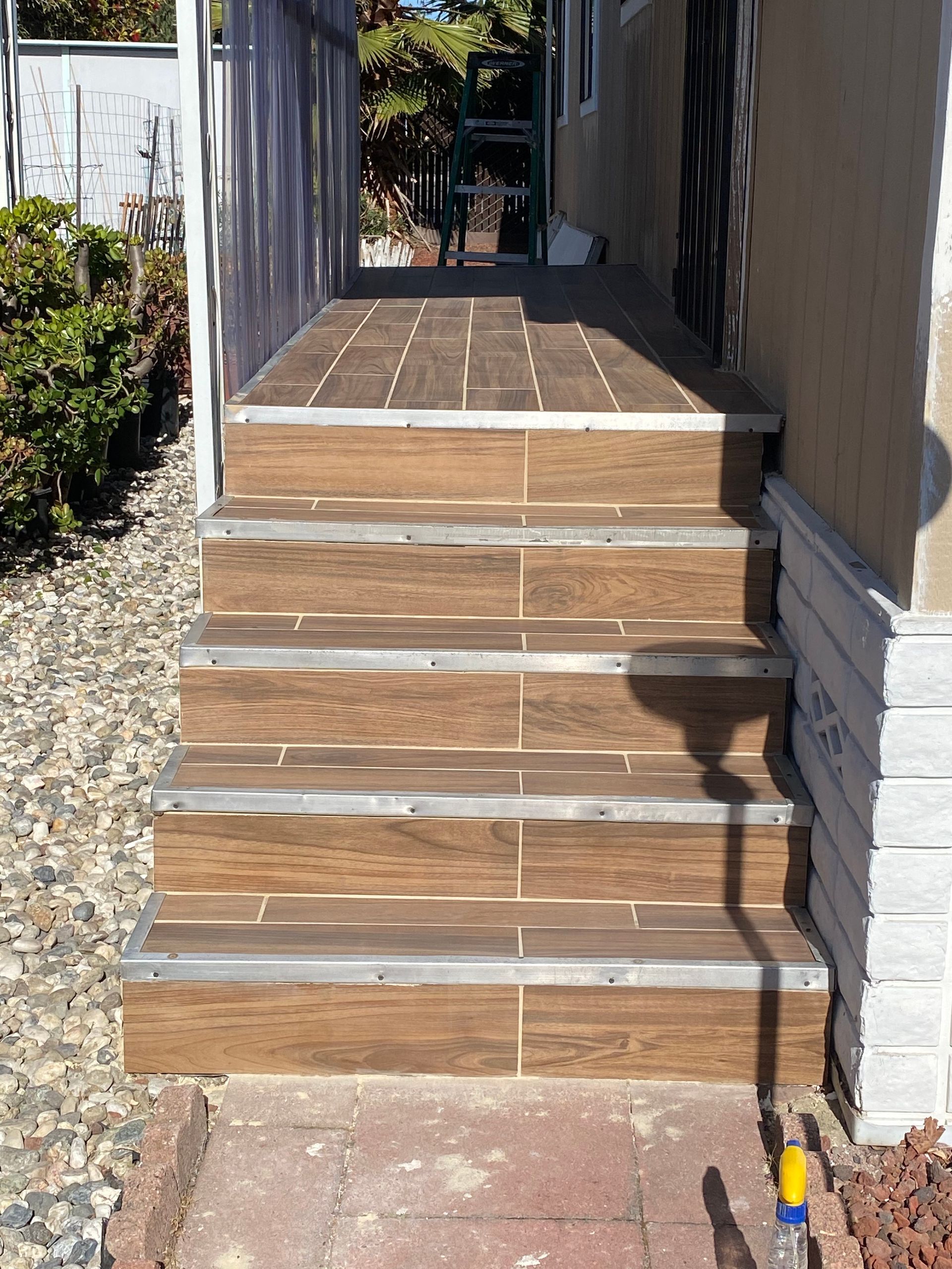 A set of wooden stairs leading up to a house.