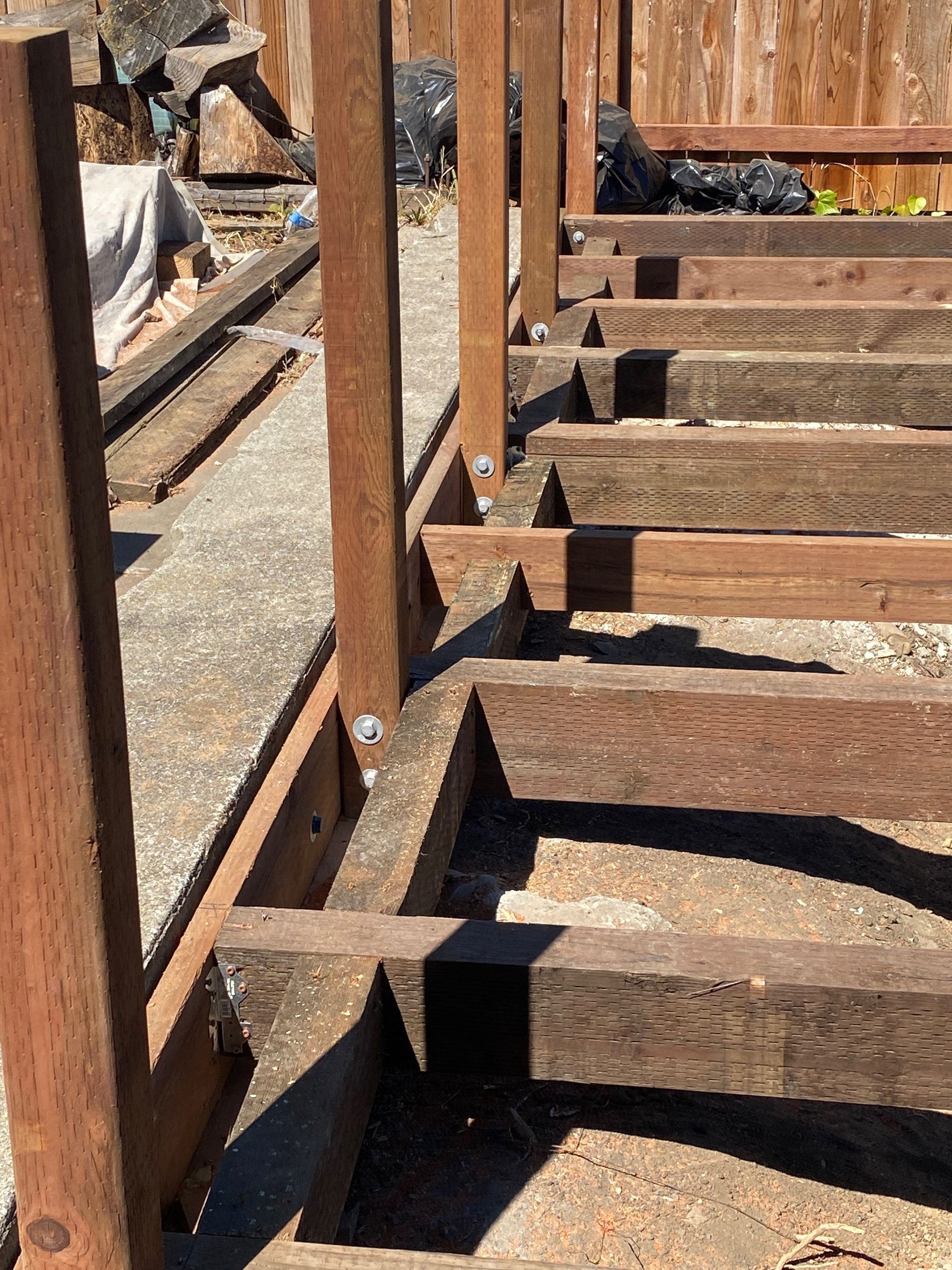 A wooden structure is being built on a concrete surface.