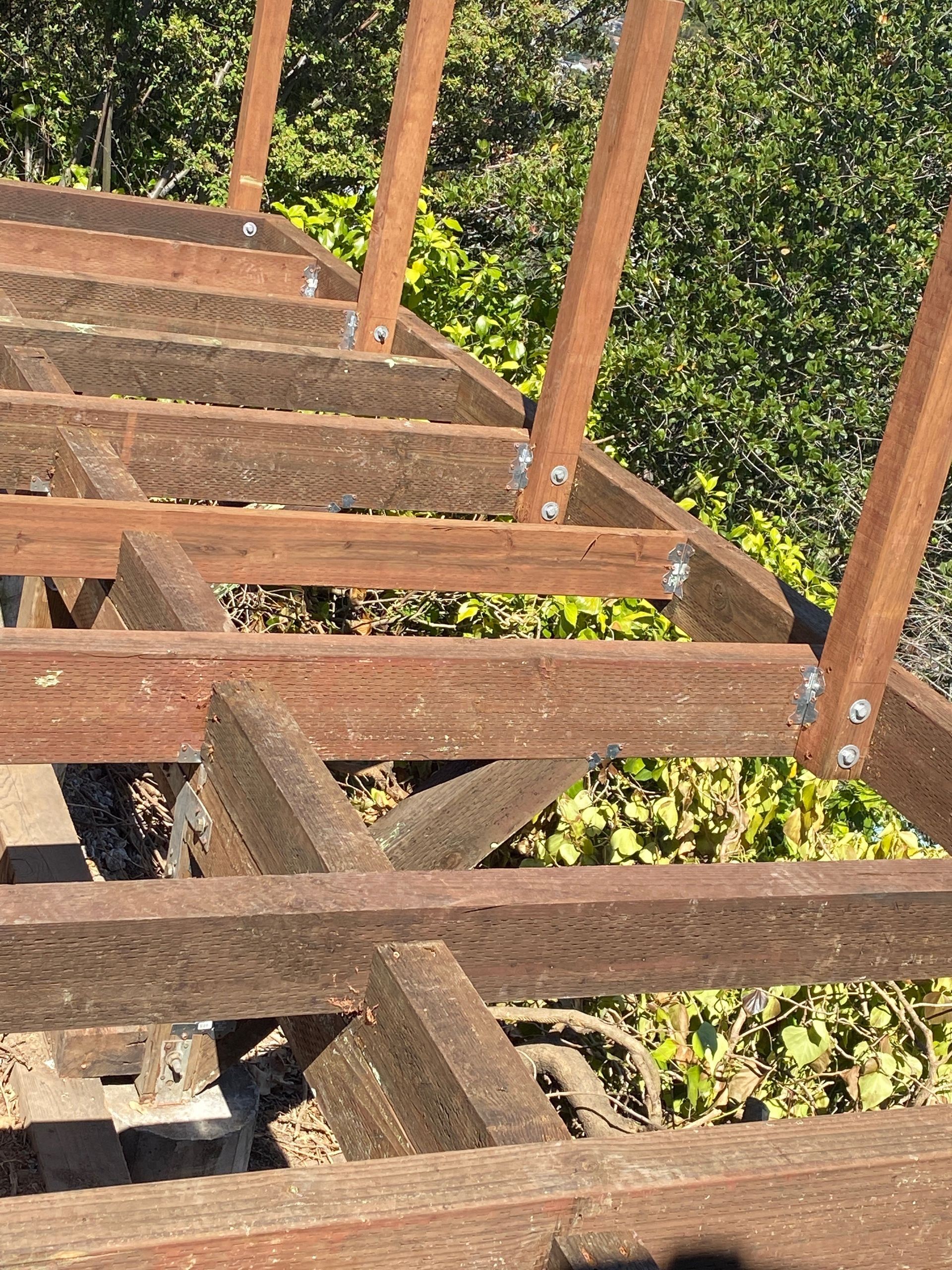 A close up of a wooden structure with trees in the background.