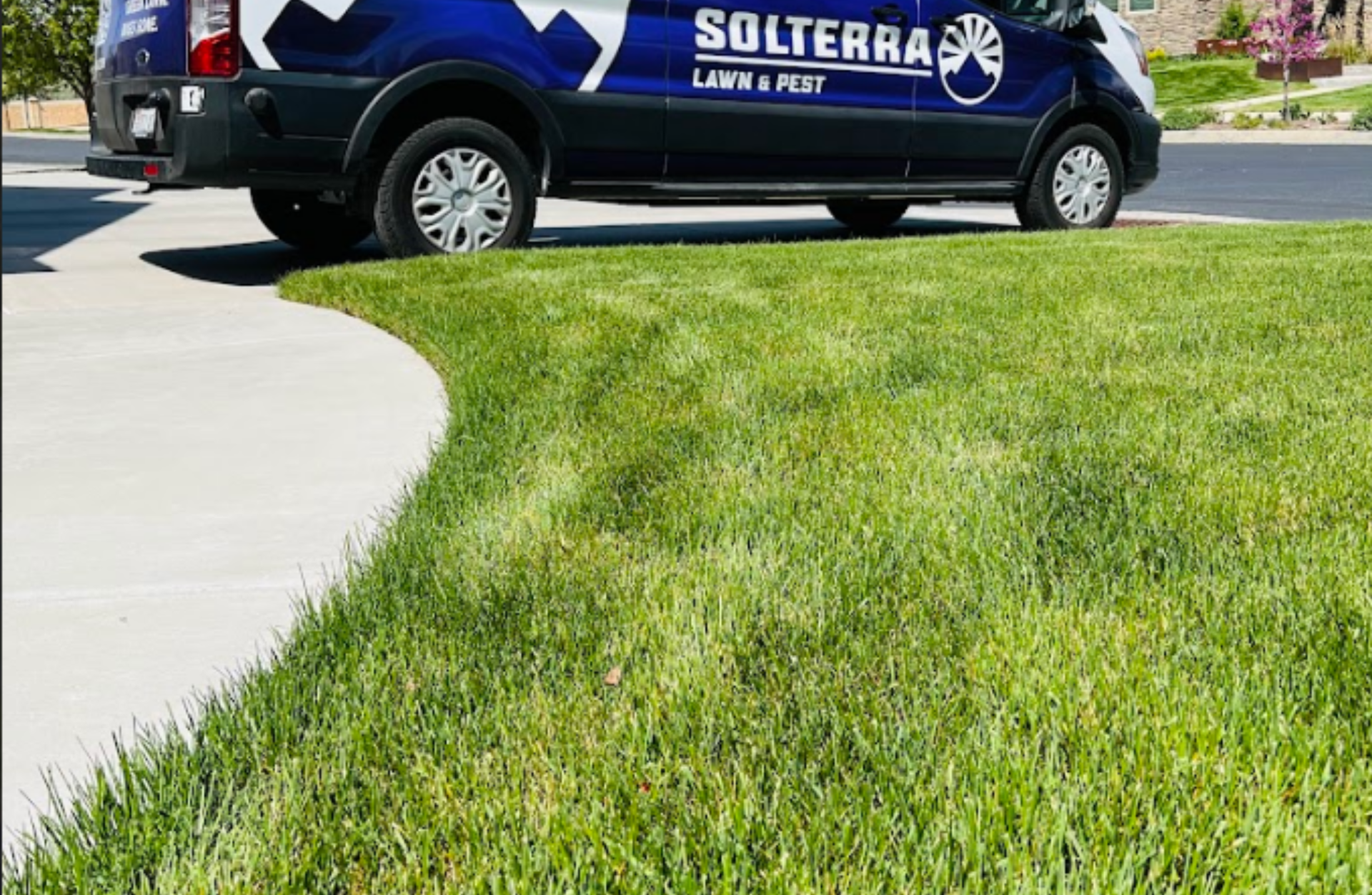 Finished yard cleanup service in Draper UT with trimmed shrubs, clean grass, and maintained commercial landscape