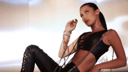 A woman is laying on the floor wearing a black outfit