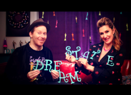 A man and a woman holding letters that spell out dream