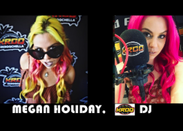 A woman with pink hair is standing in front of a microphone