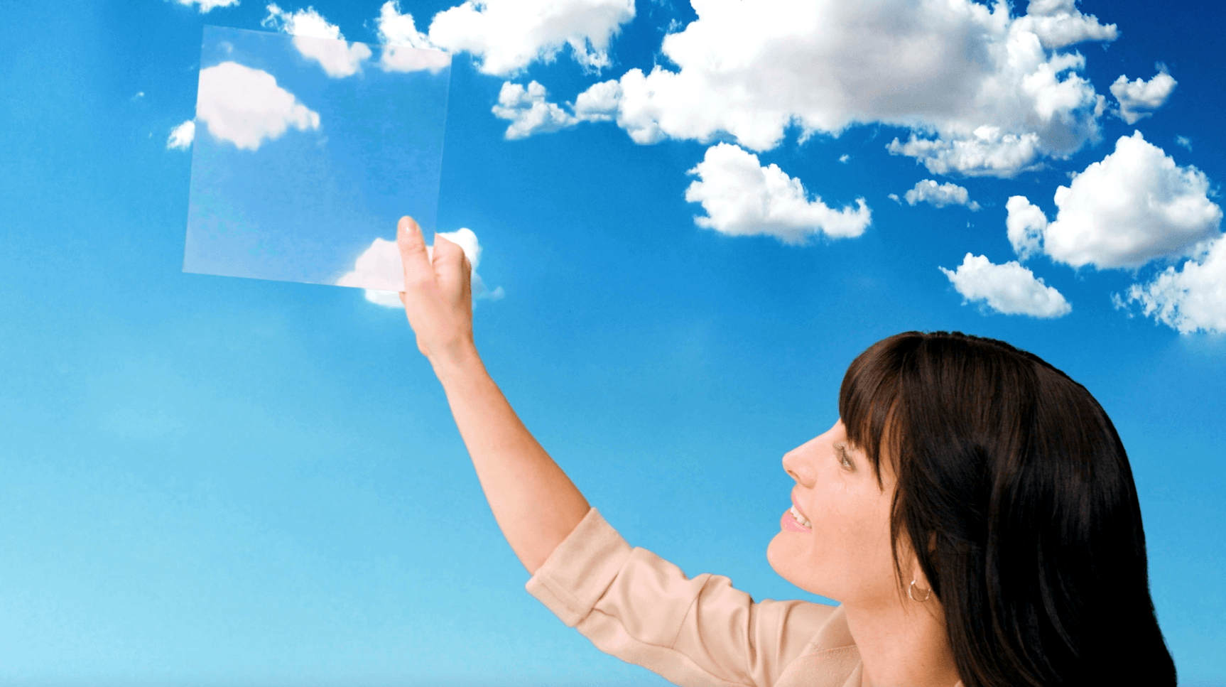 A woman is pointing at a cloud in the sky