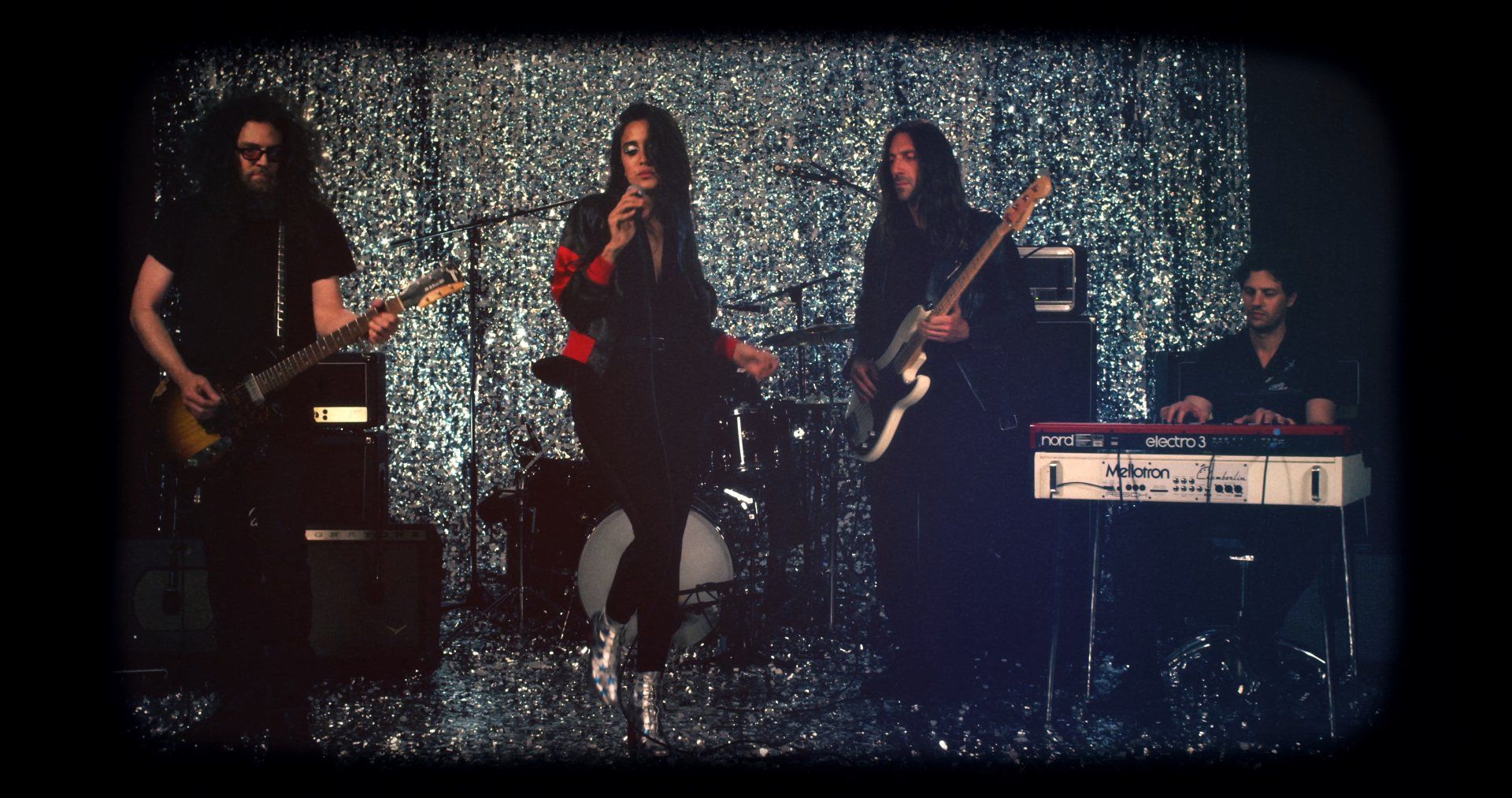 A group of people are playing instruments on a stage.