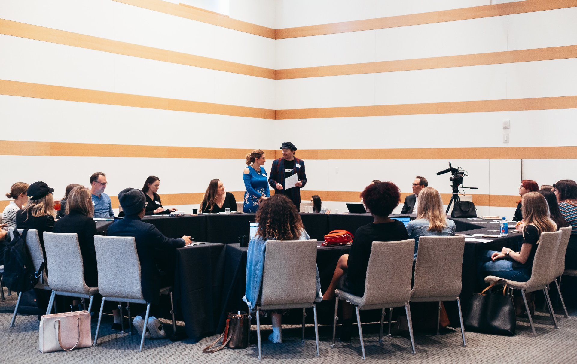 A man is giving a presentation to a group of people in a conference room.