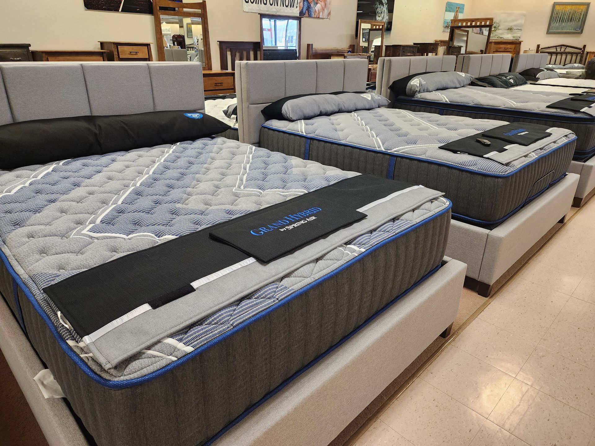 A row of mattresses are lined up in a store.