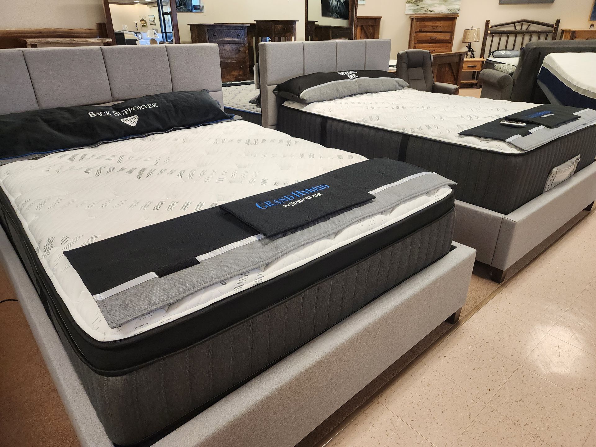Two beds are sitting next to each other in a room.