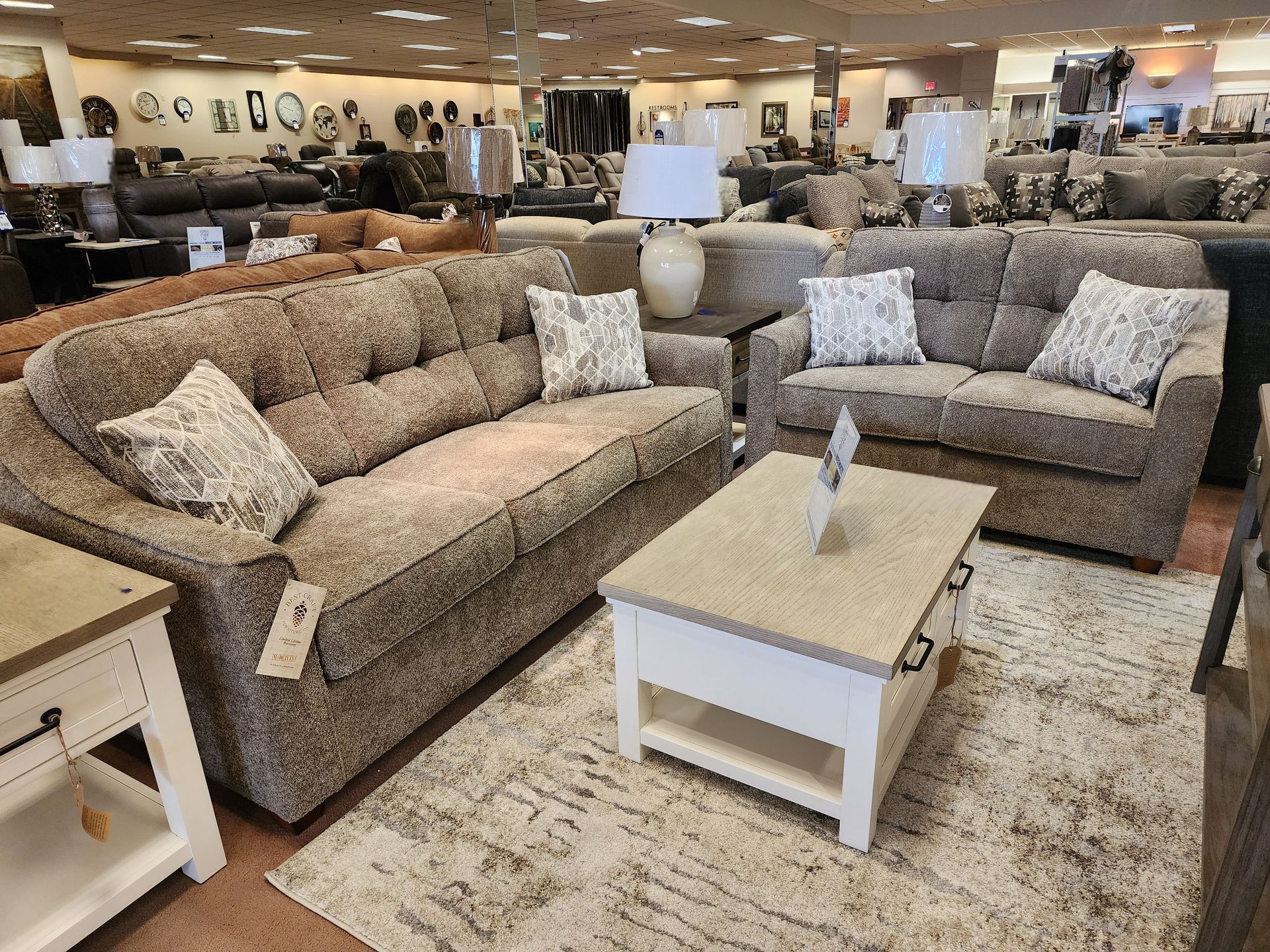 A living room with two couches and a coffee table in a furniture store.
