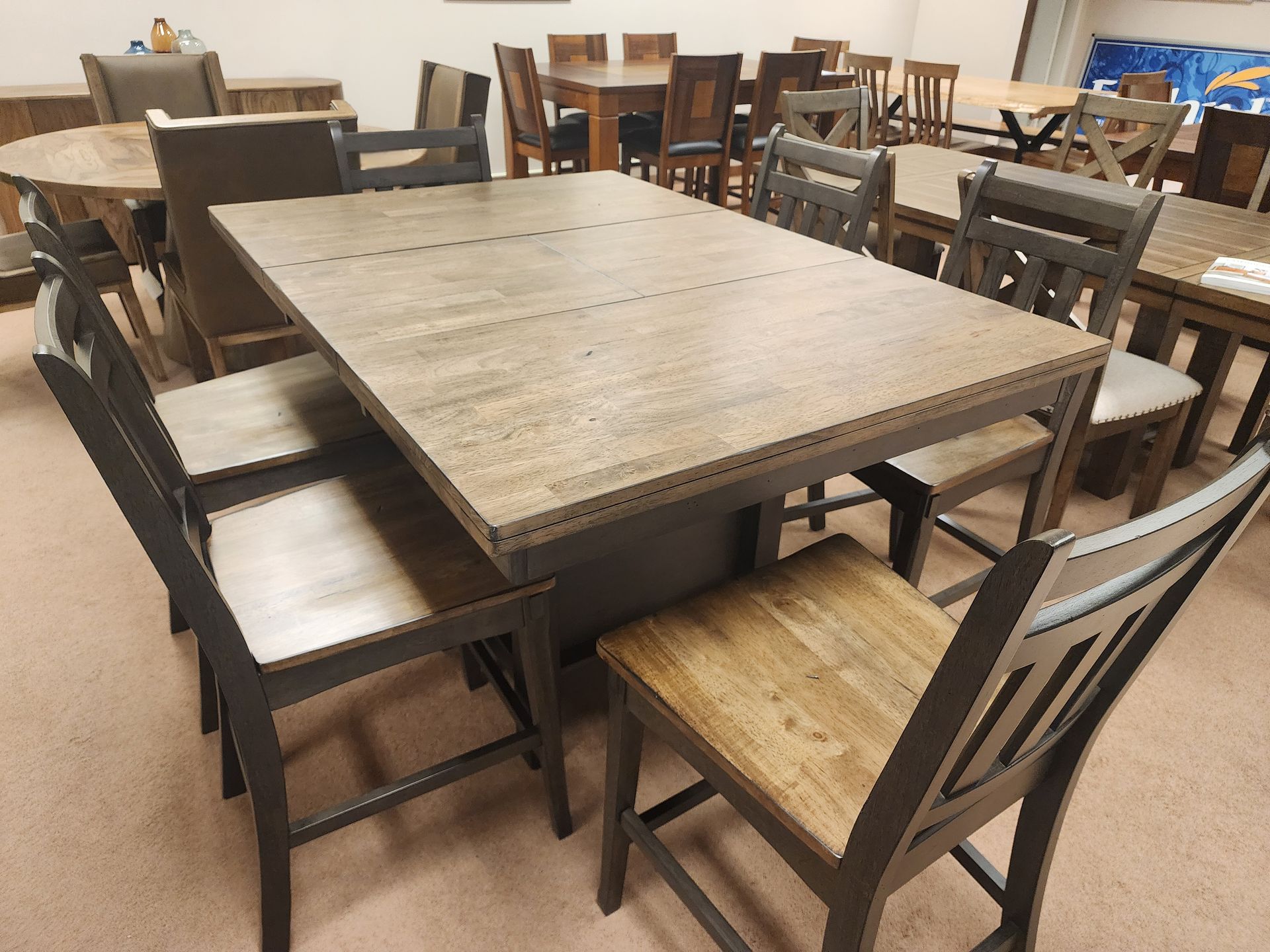A wooden table and chairs are sitting in a room.