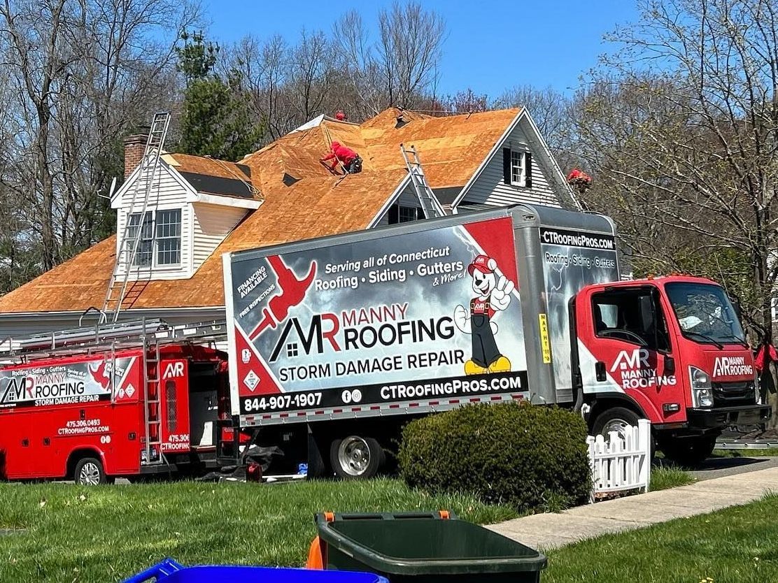 Manny Roofing team replacing a roof.