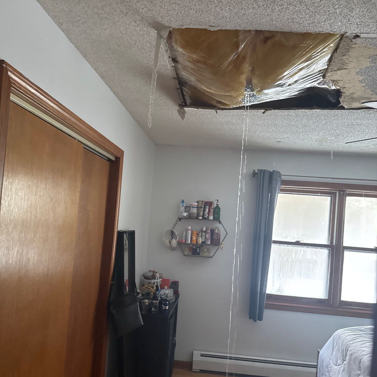 The Manny Roofing team working to restore a room damaged by a serious roof leak.