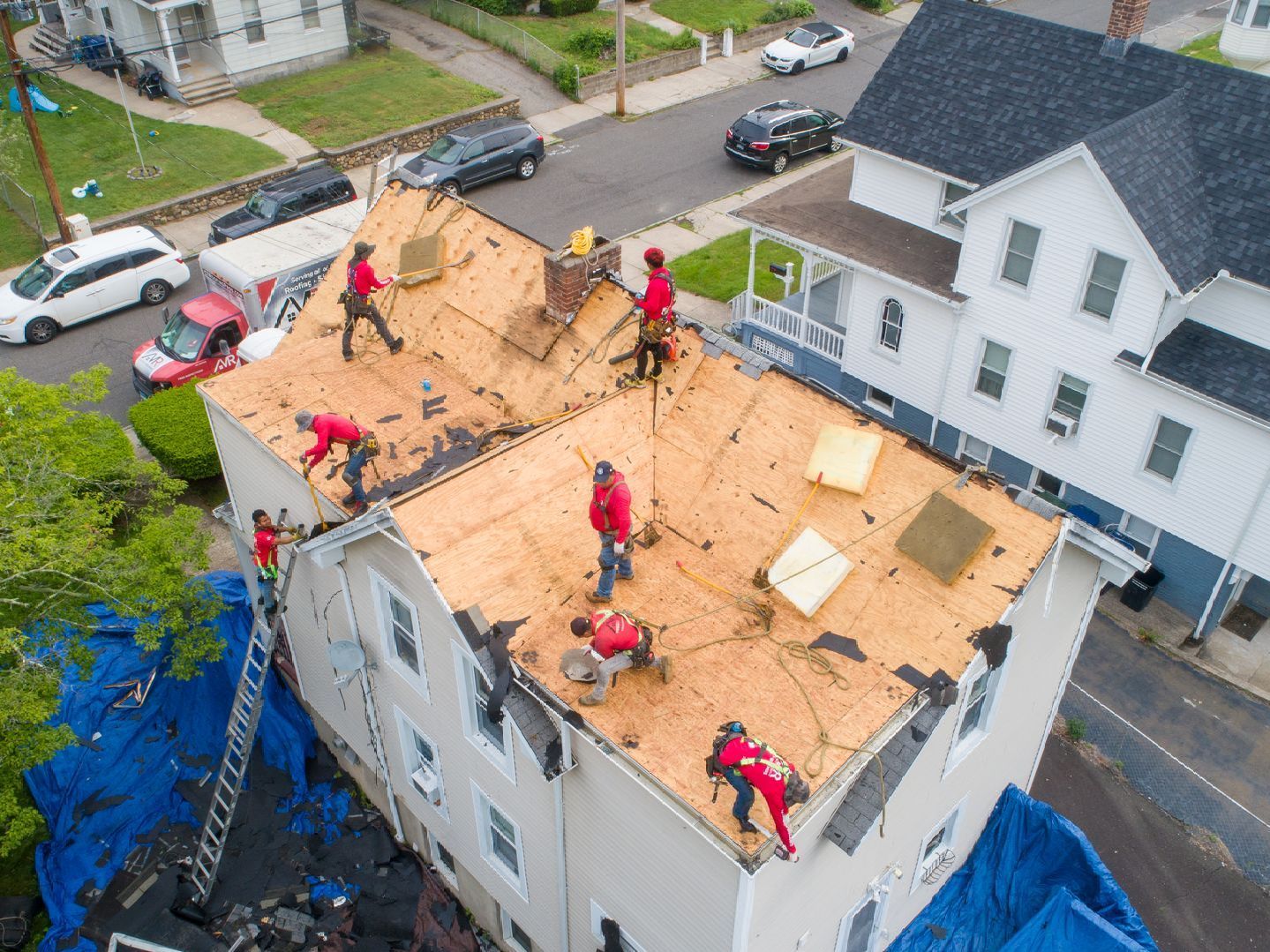 A roofer installing new roof shingles.