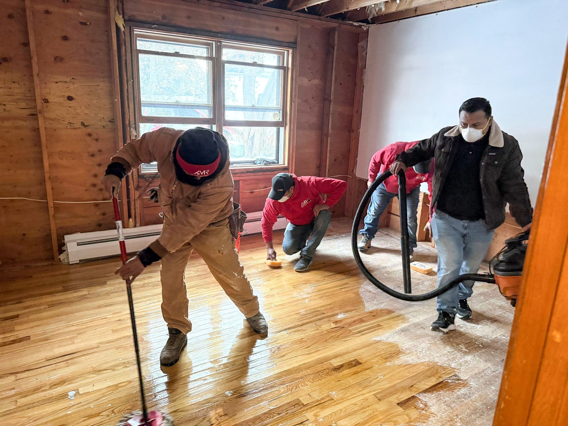 The Manny Roofing team working to restore a room damaged by a serious roof leak.