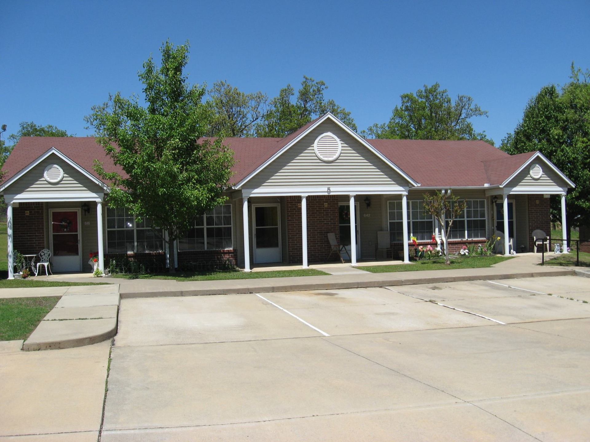 A large house with a red roof and a lot of windows