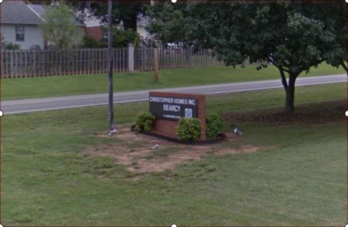 A sign in a grassy area that says legacy on it