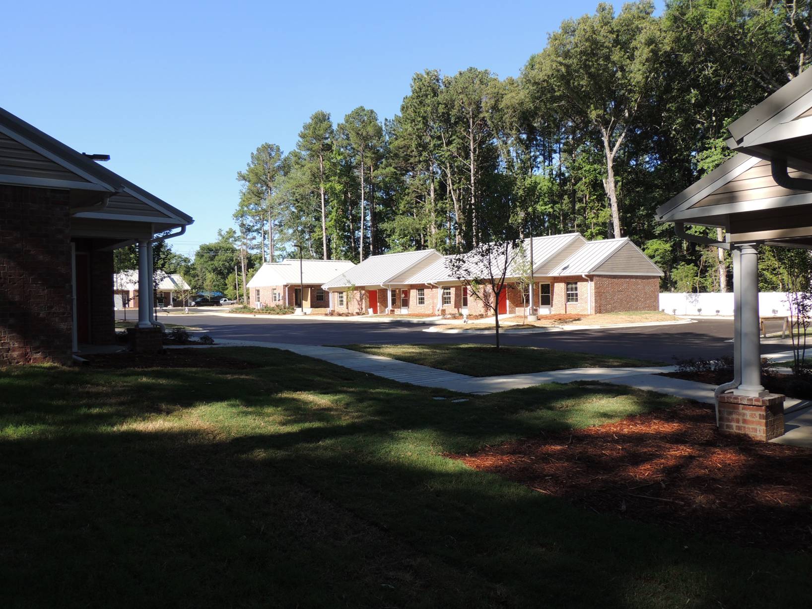 A row of houses in a residential area with trees in the background