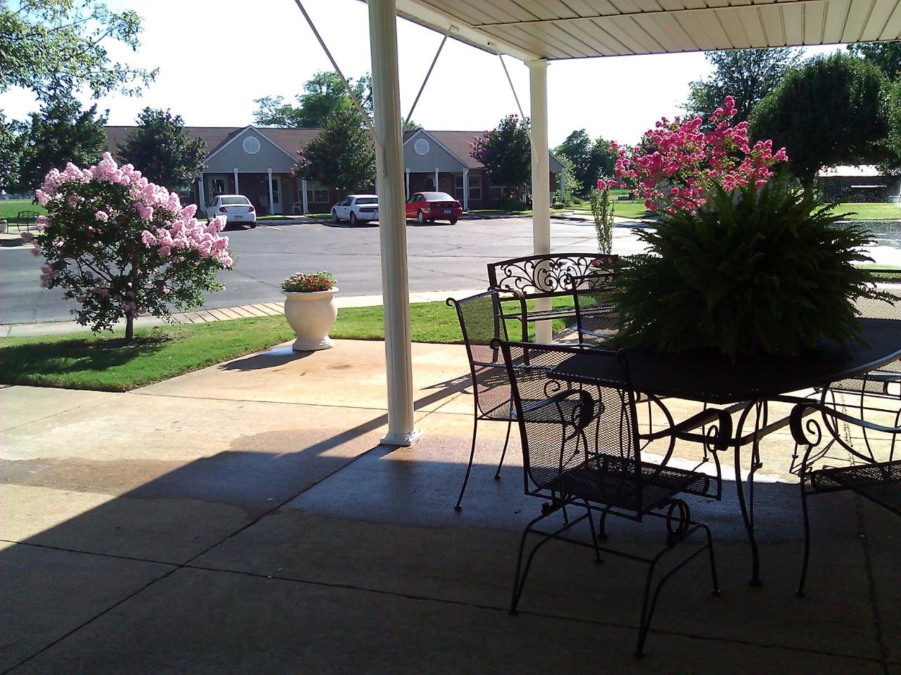 A patio with a table and chairs under a canopy