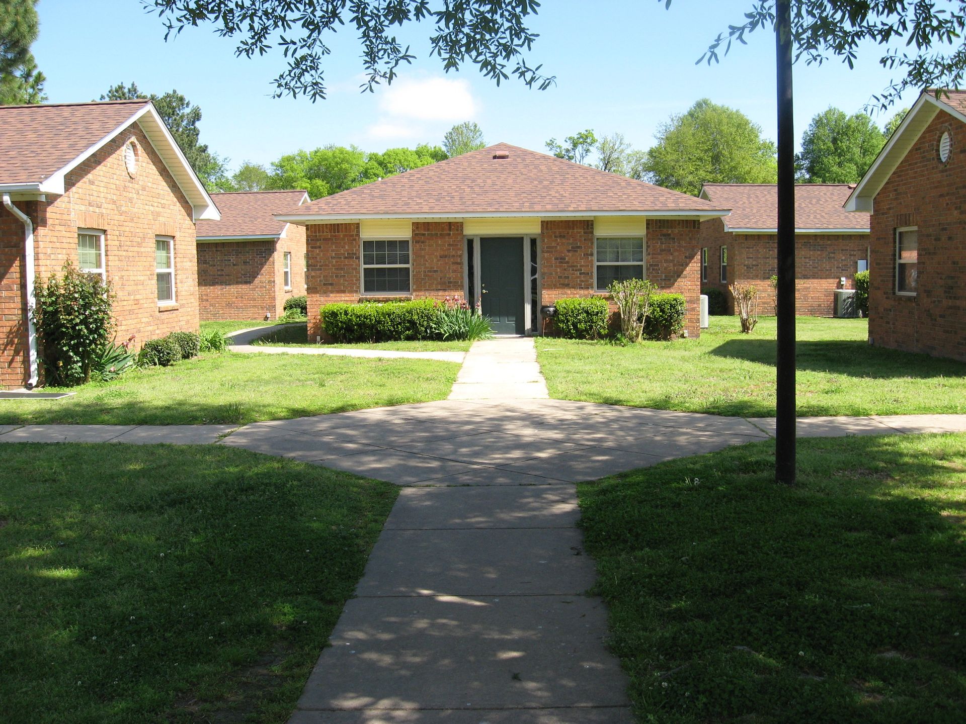A brick house with a walkway leading to it