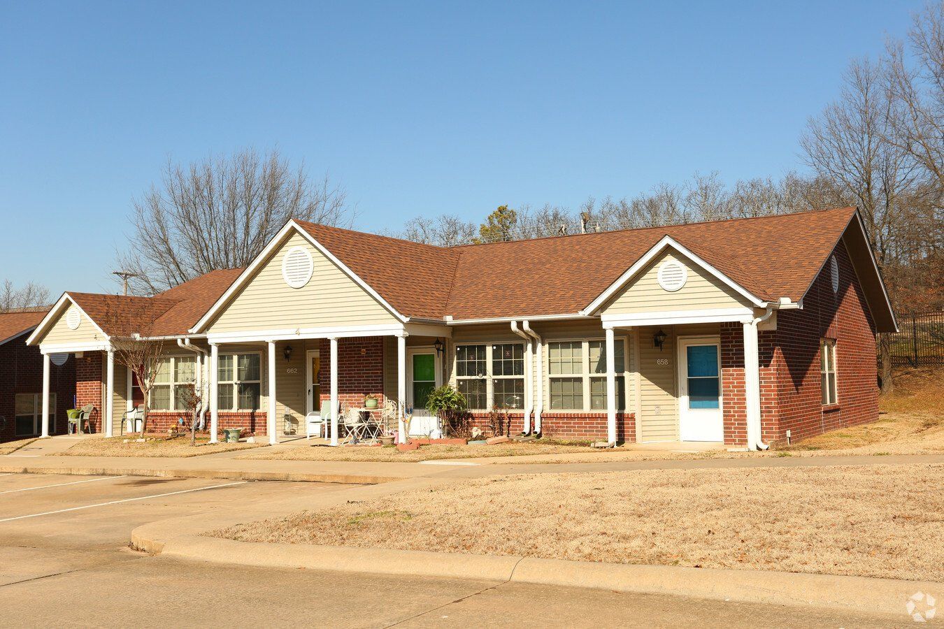 A row of houses with porches on a sunny day.