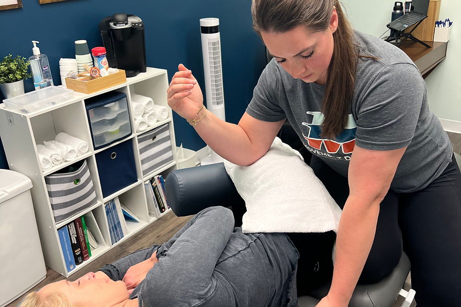 A woman is giving a person a massage in a room.