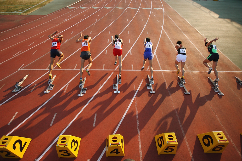 A group of athletes are getting ready to run on a track